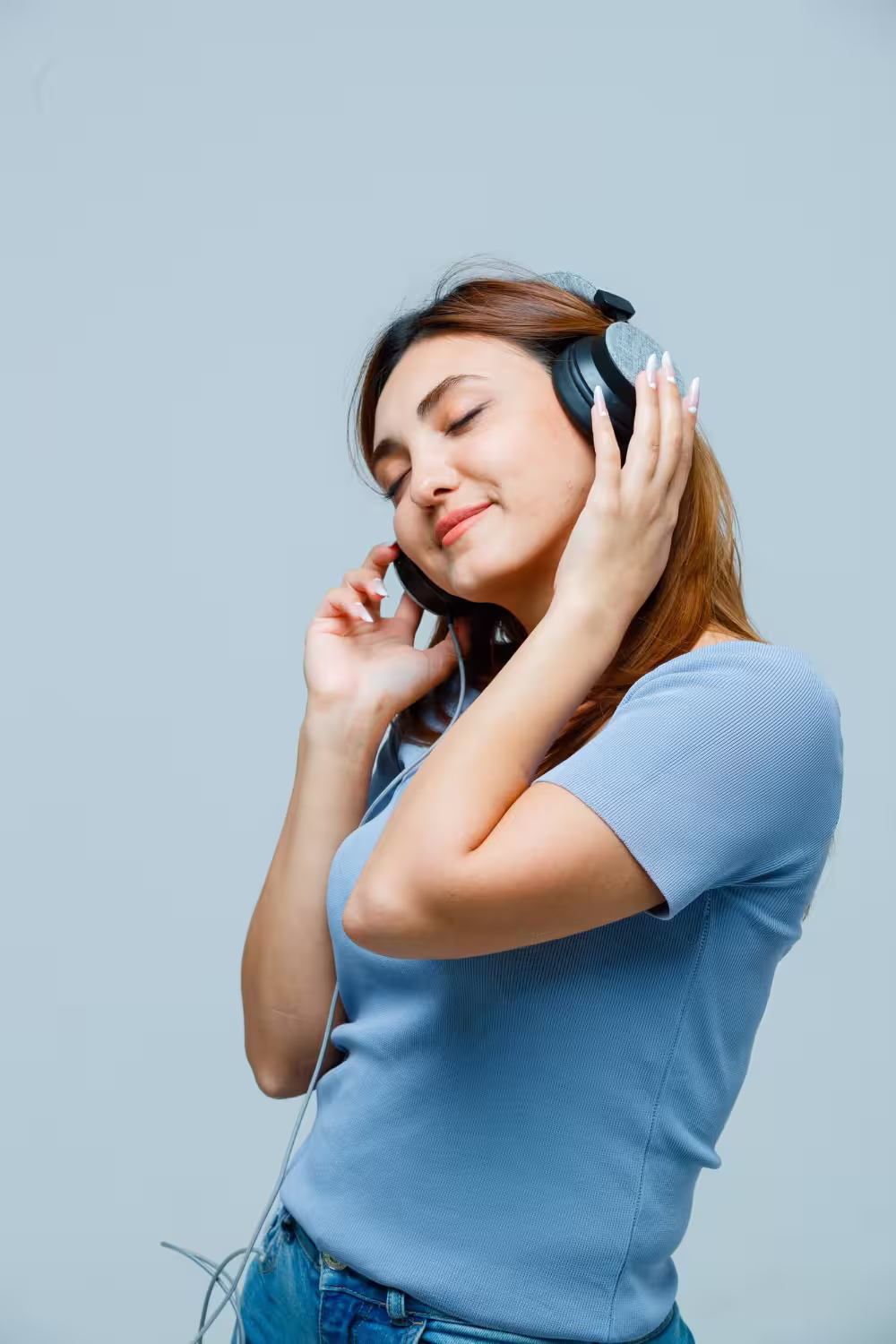 A woman listening through over-ear headphones