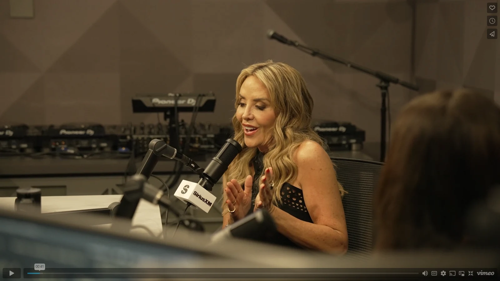 Original source photograph showing studio interview, preparation or recording work.